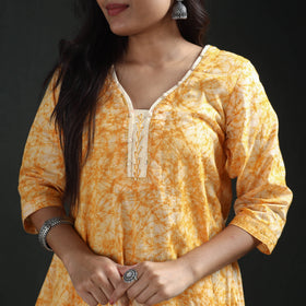 V neck, cream facing and button placket on the mustard yellow batik kurta