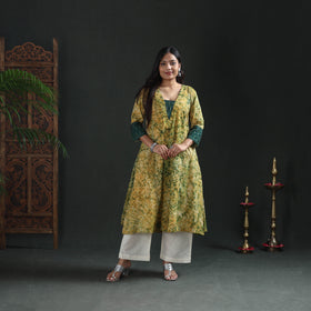 Front view of the yellow A-line batik kurta to the calf, casual wear over off-white palazzos