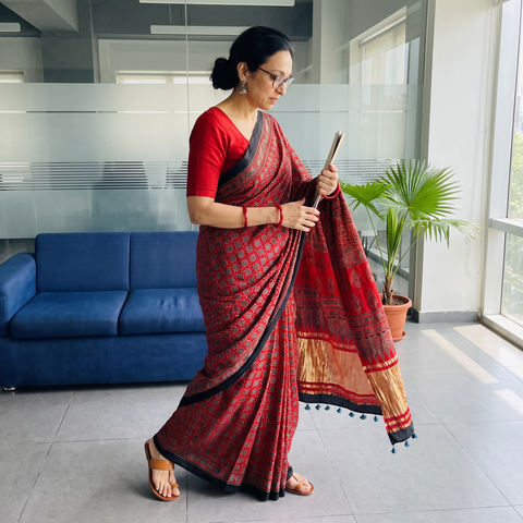 Red Ajrakh Hand Block Print Natural Dyed Lagdi Patta Border Modal Silk Saree, draped and worn by a woman, AI visual of the saree, iTokri
