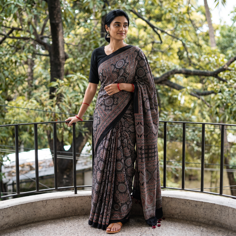 Black Ajrakh Hand Block Print Natural Dyed Modal Silk Saree, draped and worn by a woman, AI visual of the saree, iTokri
