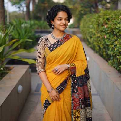 Yellow Ajrakh Hand Block Print Patchwork Pure Mul Cotton Saree, draped and worn by a woman, AI visual of the saree, iTokri