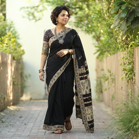 Black Ajrakh Hand Block Print Tagai & Mirror Patchwork Pure Mul Cotton Saree, draped and worn by a woman, AI visual of the saree, iTokri