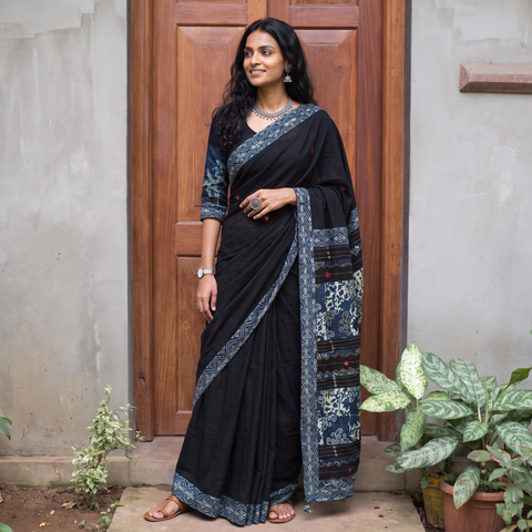 Black Ajrakh Hand Block Print Tagai & Mirror Patchwork Pure Mul Cotton Saree, draped and worn by a woman, AI visual of the saree, iTokri