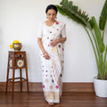 White Assam Handloom Silk Cotton Mekhela Chador with Blouse Piece, draped and worn by a woman, AI visual of the saree, iTokri