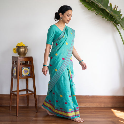 Green Assam Handloom Silk Cotton Mekhela Chador with Blouse Piece, draped and worn by a woman, AI visual of the saree, iTokri