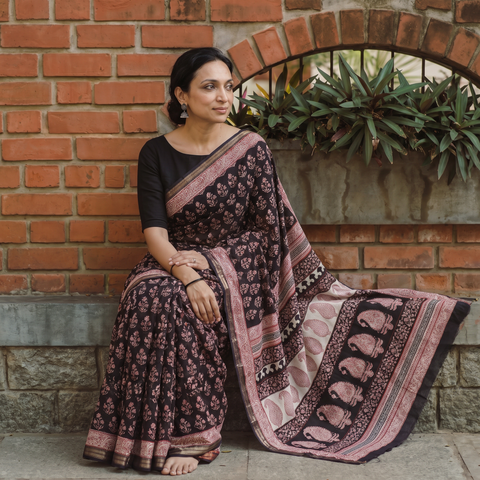 Black Bagh Hand Block Print Natural Dyed Maheshwari Silk Zari Border Saree, draped and worn by a woman, AI visual of the saree, iTokri