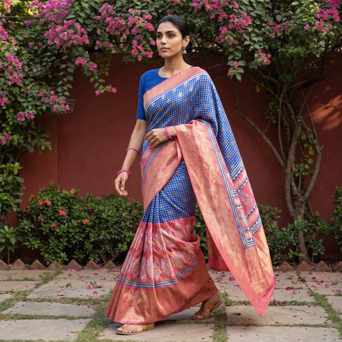 Multicolor Bagh Indigo Hand Block Print Natural Dyed Dola Silk Zari Work Saree, worn by a woman walking in a garden courtyard, AI visual of the saree, iTokri