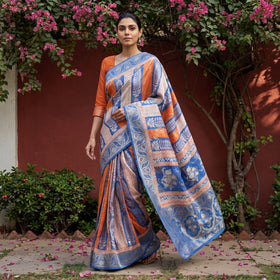 Blue Bagh Indigo Hand Block Print Natural Dyed Dola Silk Zari Work Saree, worn by a woman walking in a garden courtyard, AI visual of the saree, iTokri
