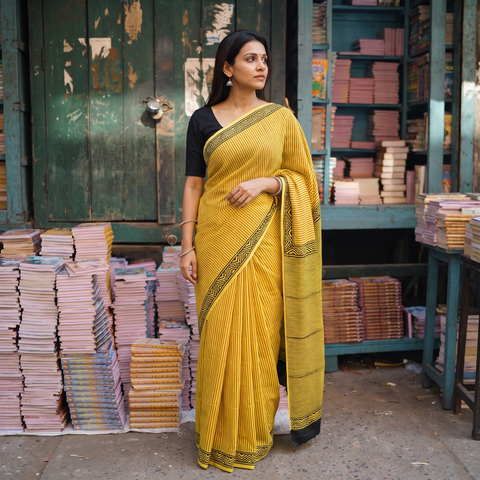 Yellow Bagru Hand Block Print Natural Dyed Modal Silk Saree, draped and worn by a woman, AI visual of the saree, iTokri