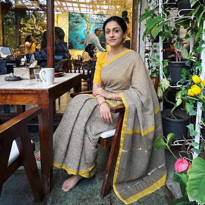 Beige Bagru Hand Block Print Natural Dyed Mulberry Silk Saree, draped and worn by a woman, AI visual of the saree, iTokri