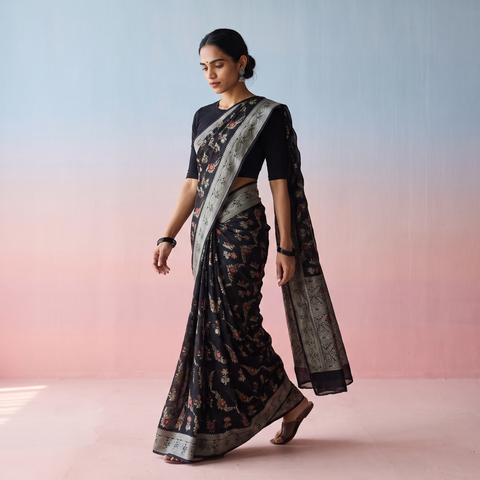 Black Banarasi Pure Handwoven Georgette Meena Buti Zari Jaal Work Saree, draped and worn by a woman, AI visual of the saree, iTokri