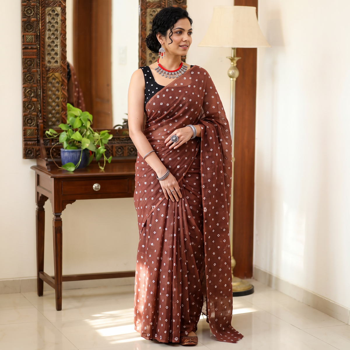 Brown Bandhani tie-dye Kota Doria cotton saree, draped and worn by a woman, by artisan Adil Hussain, AI visual of the saree, iTokri