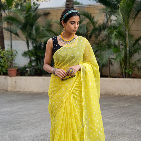 Yellow Bandhani tie-dye Kota Doria cotton saree, draped and worn by a woman, AI visual of the saree, iTokri