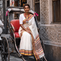 White Bengal Handwoven Cotton Begumpuri Saree, draped and worn by a woman, AI visual of the saree, iTokri
