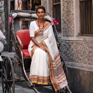 White Bengal Handwoven Cotton Begumpuri Saree, draped and worn by a woman, AI visual of the saree, iTokri