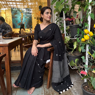 Black Bengal Pure Mul Cotton Jamdani Saree with Tassels, draped and worn by a woman, AI visual of the saree, iTokri
