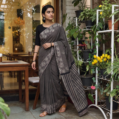 Black Bindaas Art Natural Dyed Cotton Block Print Saree, draped and worn by a woman, AI visual of the saree, iTokri