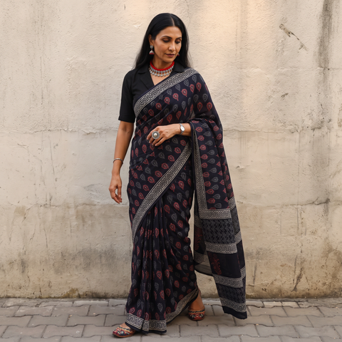 Black Sanganeri hand block print cotton saree, draped and worn by a woman, AI visual of the saree, iTokri