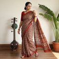 Brown Block Printed Mul Cotton Ajrakh Saree, draped and worn by a woman, AI visual of the saree, iTokri