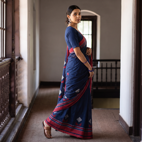 Blue Base Cotton Saree with Red & White Double Triangle & Diamond Extra Wefts Motifs on Body, draped and worn by a woman, AI visual of the saree, iTokri