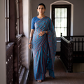 Blue Base Silk Cotton Saree with Red & Black Buti Flower on Pallu with Red Stripes on Body, draped and worn by a woman, AI visual of the saree, iTokri