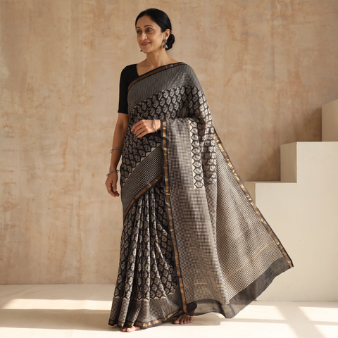 Black Chanderi Silk Hand Block Print Bagru Saree with Zari Border, draped and worn by a woman, AI visual of the saree, iTokri