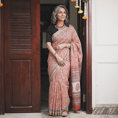 Orange Chanderi silk hand block print Sanganeri saree with ghicha border, draped and worn by a woman, AI visual of the saree, iTokri