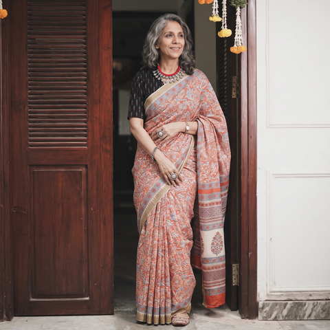 Orange Chanderi silk hand block print Sanganeri saree with ghicha border, draped and worn by a woman, AI visual of the saree, iTokri