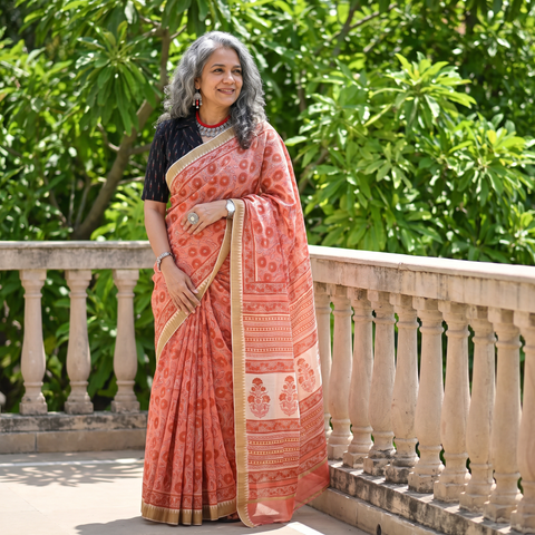 Pink Chanderi silk hand block print Sanganeri saree with ghicha border, draped and worn by a woman, AI visual of the saree, iTokri