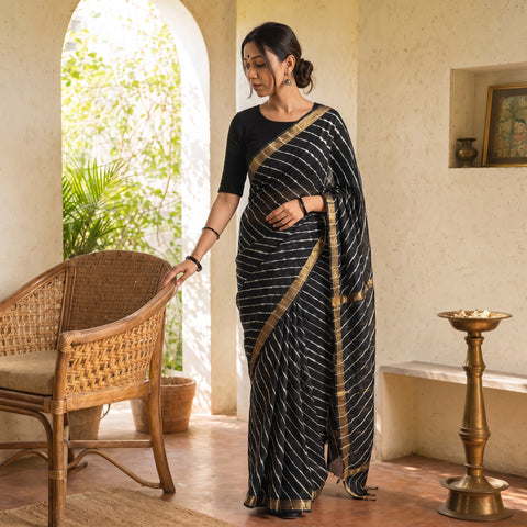 Black Chanderi Silk Leheriya Tie-Dye Saree with Zari Border, draped and worn by a woman, AI visual of the saree, iTokri