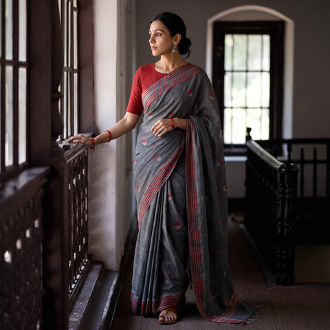 Charcoal Cotton Grey Saree with Red & Beige Buti, draped and worn by a woman, AI visual of the saree, iTokri