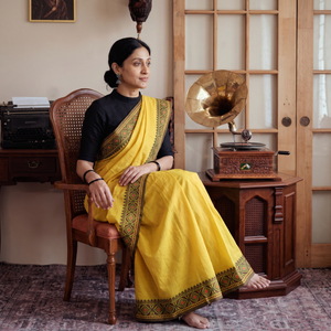 Yellow Chettinad Woven Cotton Saree with Border, draped and worn by a woman, AI visual of the saree, iTokri