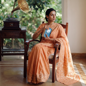 Peach Chinon Silk Hand Embroidery Phulkari Saree, draped and worn by a woman, AI visual of the saree, iTokri
