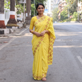Yellow Chinon Silk Hand Embroidery Phulkari Saree, draped and worn by a woman, AI visual of the saree, iTokri