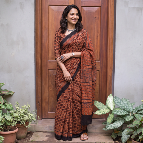 Red Ajrakh hand block print natural dyed cotton saree, draped and worn by a woman, AI visual of the saree, iTokri