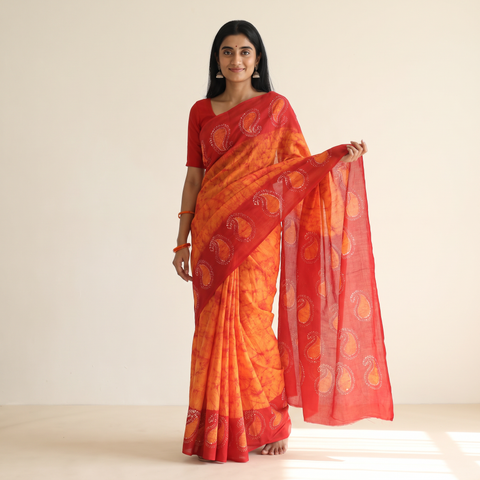 Orange Cotton Hand Batik Print Saree, draped and worn by a woman, AI visual of the saree, iTokri