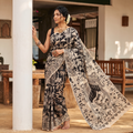Black Cotton Saree in Kalamkari Print, draped and worn by a woman, AI visual of the saree, iTokri