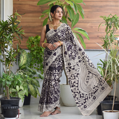 Black Cotton Saree in Kalamkari Print, draped and worn by a woman, AI visual of the saree, iTokri