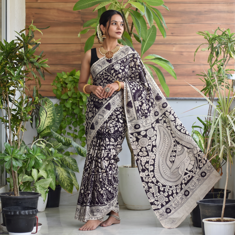 Black Cotton Saree in Kalamkari Print, draped and worn by a woman, AI visual of the saree, iTokri