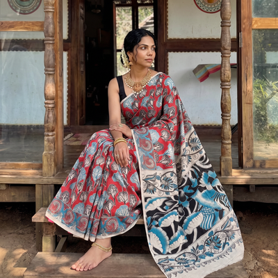 Red Cotton Saree in Kalamkari Print, draped and worn by a woman, AI visual of the saree, iTokri