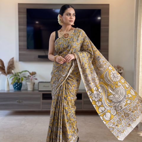 Yellow Cotton Saree in Kalamkari Print, draped and worn by a woman, AI visual of the saree, iTokri