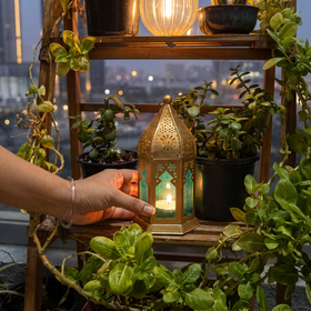 Decorative Handmade Hanging Candle Lantern, lit in a home in the evening, AI visual of the light, iTokri