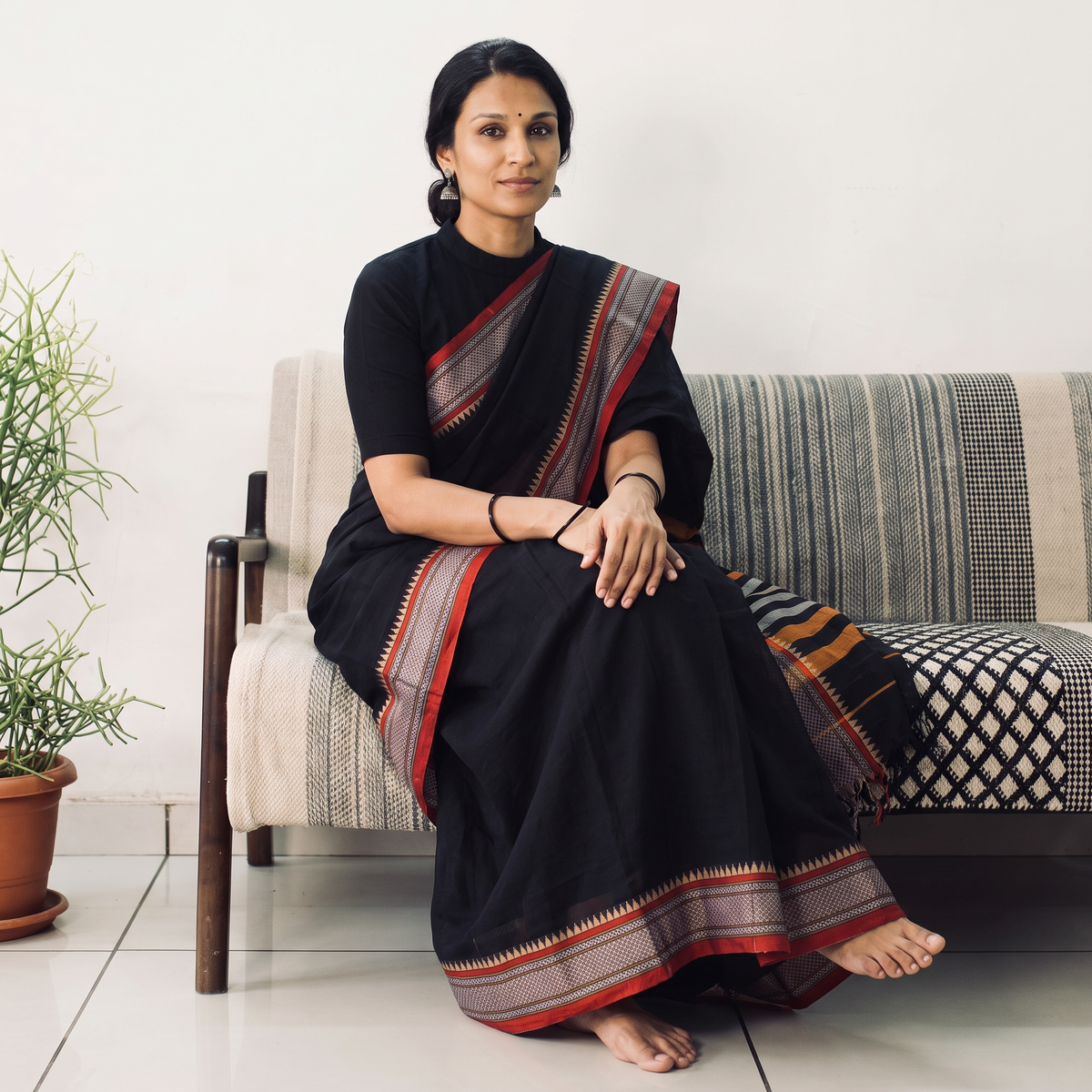 Black Dharwad Cotton Saree with Border, draped and worn by a woman, AI visual of the saree, iTokri
