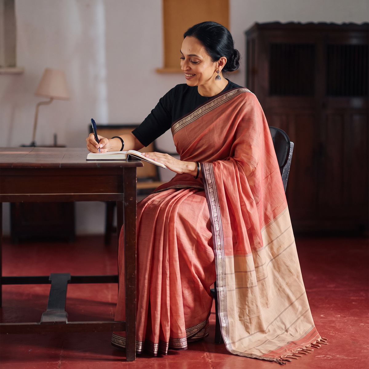 Peach Dharwad Woven Mercerised Cotton Saree with Border, draped and worn by a woman, AI visual of the saree, iTokri