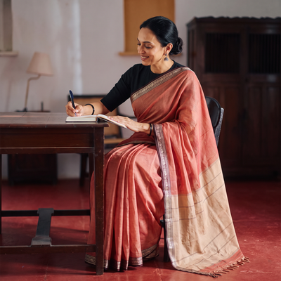 Peach Dharwad Woven Mercerised Cotton Saree with Border, draped and worn by a woman, AI visual of the saree, iTokri