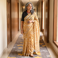 Yellow floral hand block print mulberry silk Sanganeri saree, draped and worn by a woman, by artisan Prem Dosaya, AI visual of the saree, iTokri