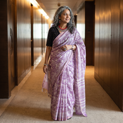 Purple floral hand block print mulberry silk Sanganeri saree, draped and worn by a woman, by artisan Prem Dosaya, AI visual of the saree, iTokri