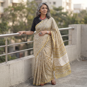Yellow floral hand block print mulberry silk Sanganeri saree, draped and worn by a woman, by artisan Prem Dosaya, AI visual of the saree, iTokri