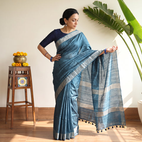Blue Ghicha Tussar Silk Bhagalpuri Pure Handwoven Saree with Zari Border, draped and worn by a woman, AI visual of the saree, iTokri