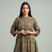 Front hip-up view of an olive green Kalamkari block print cotton kurta with climbing vine flowers, on a model
